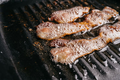 High angle view of meat on barbecue grill