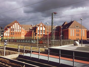 Railroad track against cloudy sky