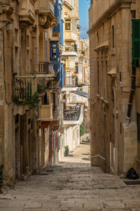 Narrow alley amidst buildings in city