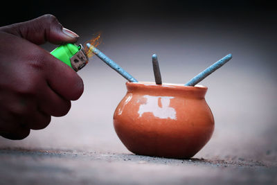 Close-up of hand holding cigarette