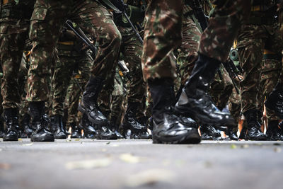  low view of the legs of brazilian army soldiers marching through the streets 