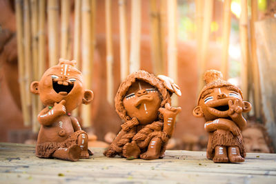 Clay doll of domestic indigenous people on africa on bamboo table.