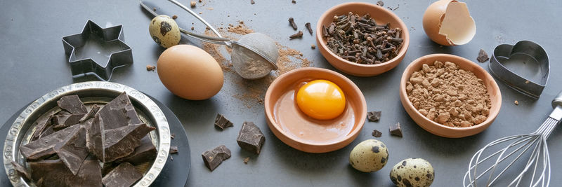 Mix of baking dessert ingredients on dark background, culinary flat lay