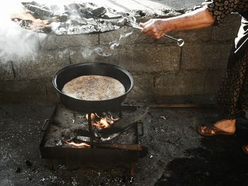 Midsection of woman cooking on street