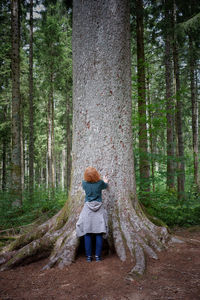 Rear view of girl walking in forest