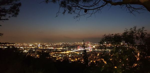 High angle view of illuminated buildings against sky at night