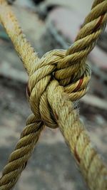 Close-up of rope tied up on metal