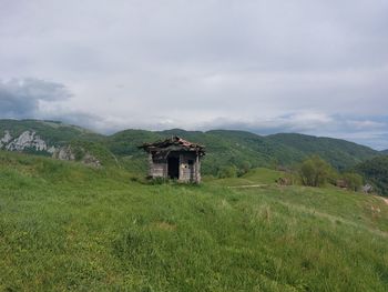 Built structure on field against sky