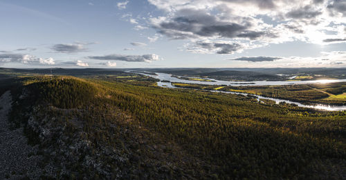 Scenic view of land and sea against sky