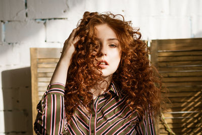 Portrait of a young red-haired woman with sad eyes