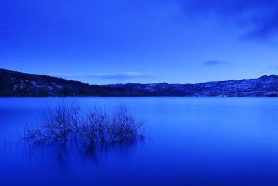 Scenic view of lake against sky during winter