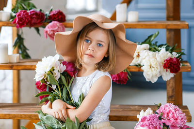 Portrait of a girl with pink flower bouquet