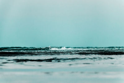 Surface level of sea against clear sky