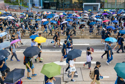 High angle view of people walking on street in rain