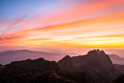 Scenic view of mountains against orange sky