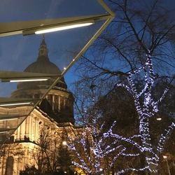 Low angle view of illuminated building against sky at night