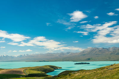 Scenic view of turquoise lake tekapo and mountains against sky