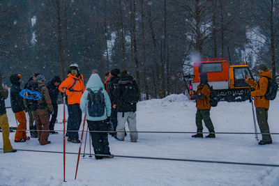 People standing on snow covered land