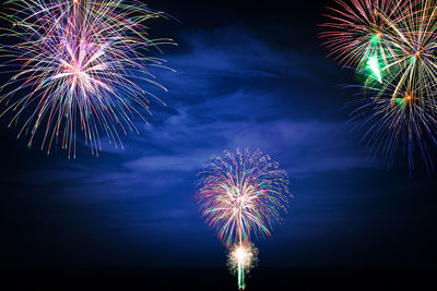 Low angle view of firework display at night