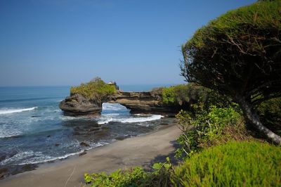 Scenic view of beach against clear blue sky