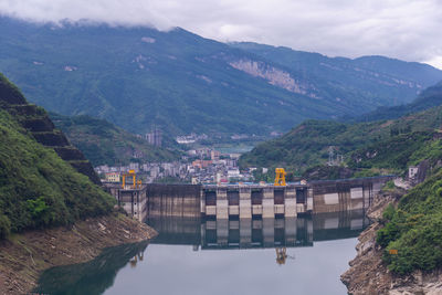 Scenic view of river amidst mountains against sky