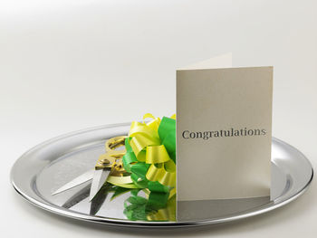 Close-up of drink served on table against white background