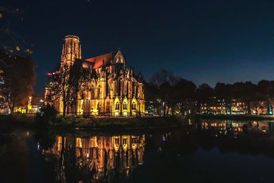 Reflection of illuminated buildings in lake at night