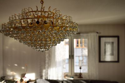 Close-up of illuminated chandelier hanging on ceiling