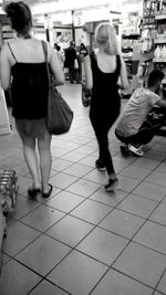 Full length of woman standing on sidewalk