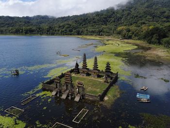 High angle view of lake by trees against sky