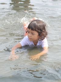 High angle view of boy enjoying in lake