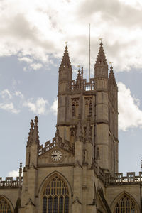 Low angle view of church against cloudy sky