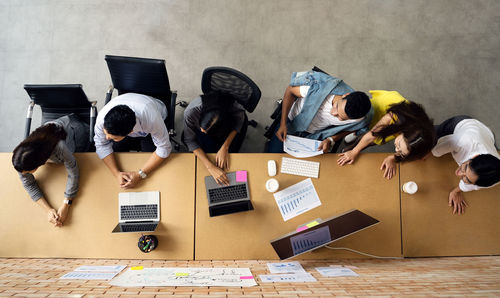 High angle view of people working on table