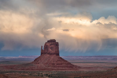 View of desert against cloudy sky