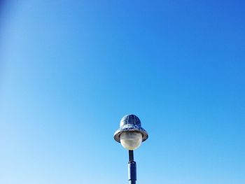 Low angle view of lamp against clear blue sky