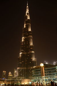 Low angle view of illuminated buildings against sky at night