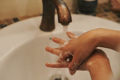 Midsection of woman in bathroom at home