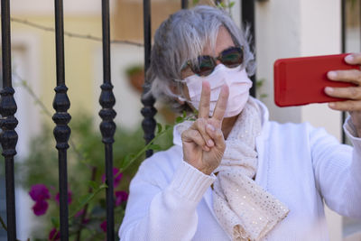 Midsection of woman photographing with mobile phone