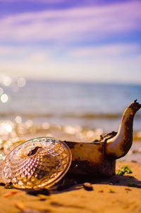 Close-up of rusty metal by sea