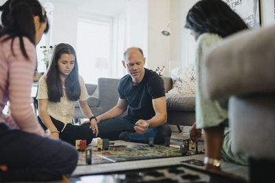 Family relaxing at home playing board games