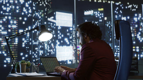 Portrait of young man using laptop at home