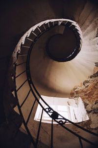 Directly below view of spiral staircase in abandoned building