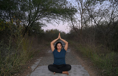 Beautiful female teacher doing yoga asanas and meditation poses 