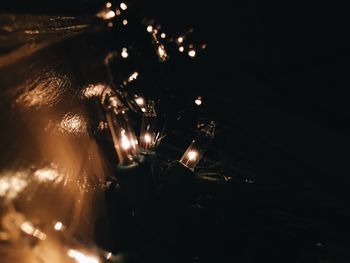 Close-up of illuminated christmas lights at night