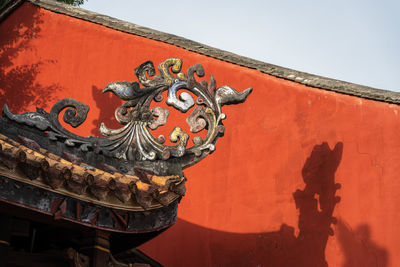 South china history building roof shadow on red wall