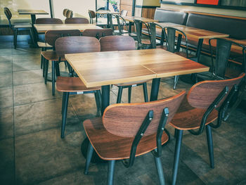 Empty chairs and tables in cafe