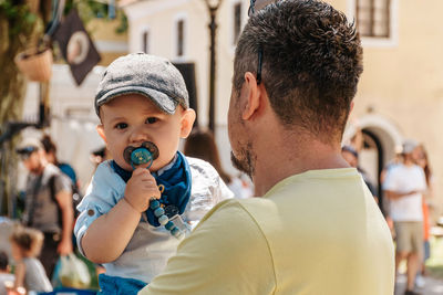 Close-up photo of father holding his baby boy