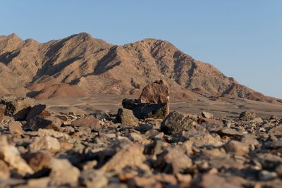 Surface level of rocks on arid landscape against clear sky