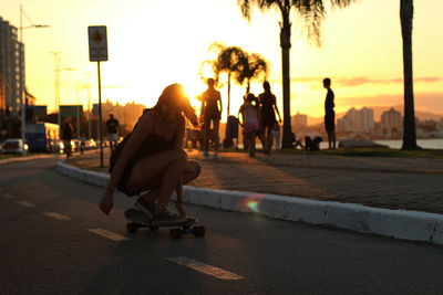 People on road at sunset