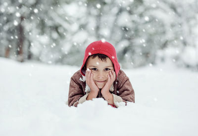 Portrait of young woman standing on snow